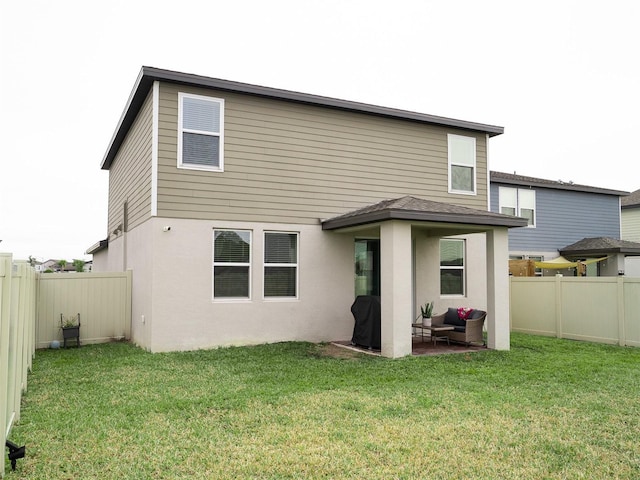 back of house featuring a yard and a patio area