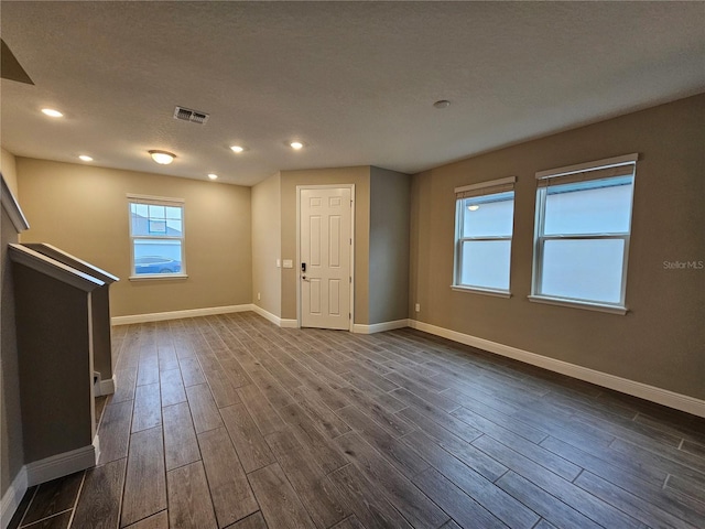 unfurnished room featuring a textured ceiling