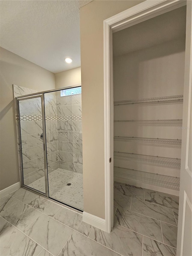 bathroom featuring a shower with shower door