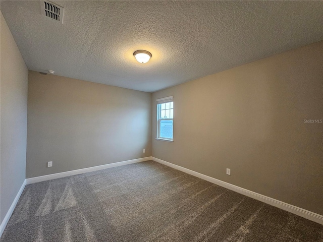 spare room with carpet floors and a textured ceiling