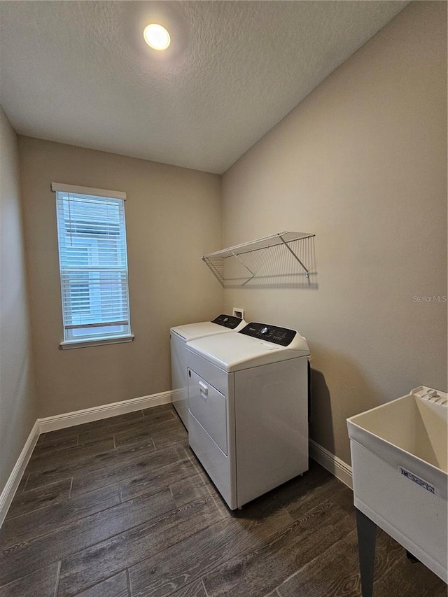 laundry area with independent washer and dryer, dark hardwood / wood-style flooring, sink, and a textured ceiling