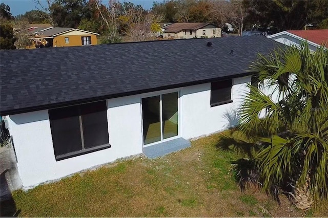 rear view of house featuring a yard