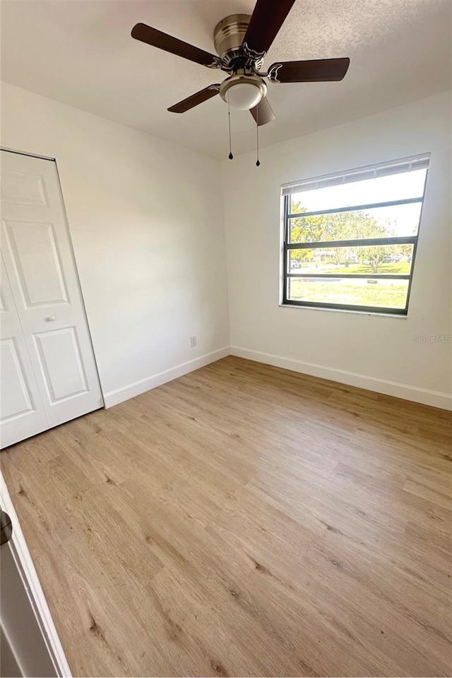 unfurnished room featuring light wood-type flooring and baseboards