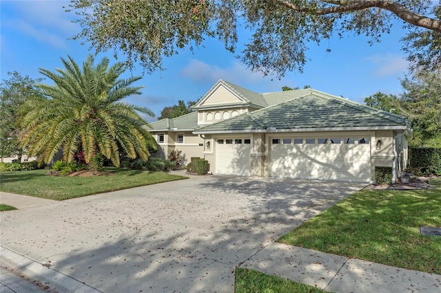 view of property featuring a garage and a front yard