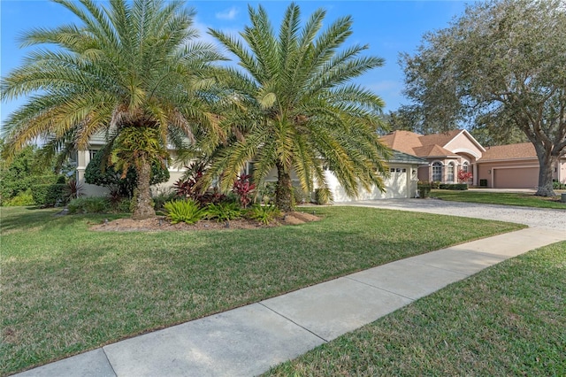 view of front of property featuring a garage and a front lawn