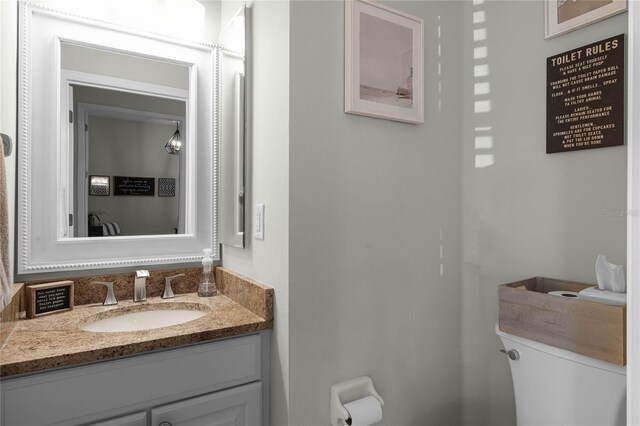 bathroom with vanity and toilet