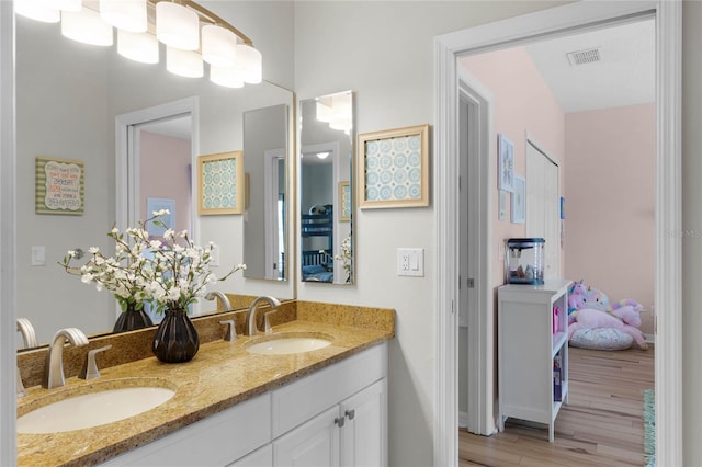 bathroom with hardwood / wood-style flooring and vanity