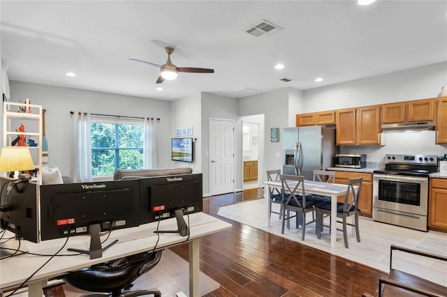 kitchen featuring ceiling fan, appliances with stainless steel finishes, and light hardwood / wood-style flooring