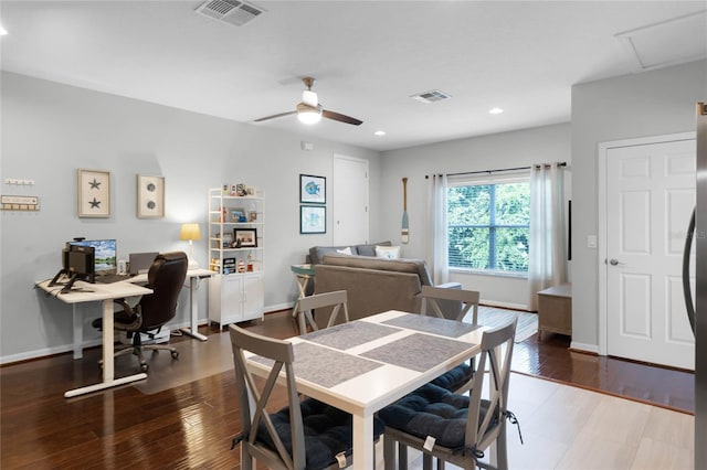 dining space with wood-type flooring and ceiling fan