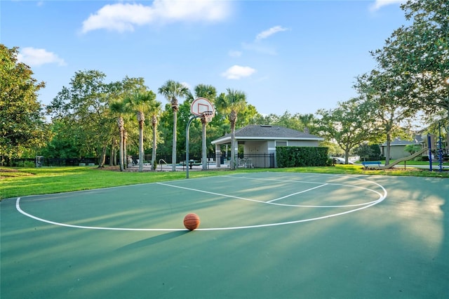 view of basketball court with a lawn