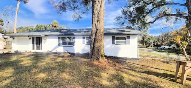 back of property featuring a yard and a garage