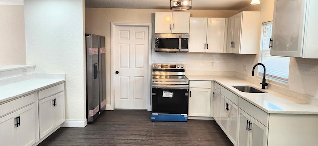 kitchen featuring stainless steel appliances, sink, white cabinets, and dark hardwood / wood-style floors