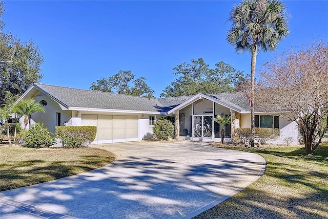 single story home with a garage and a front lawn