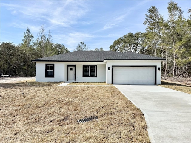 ranch-style home featuring a garage and a front yard