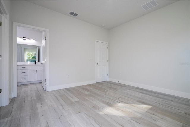 empty room with light hardwood / wood-style flooring