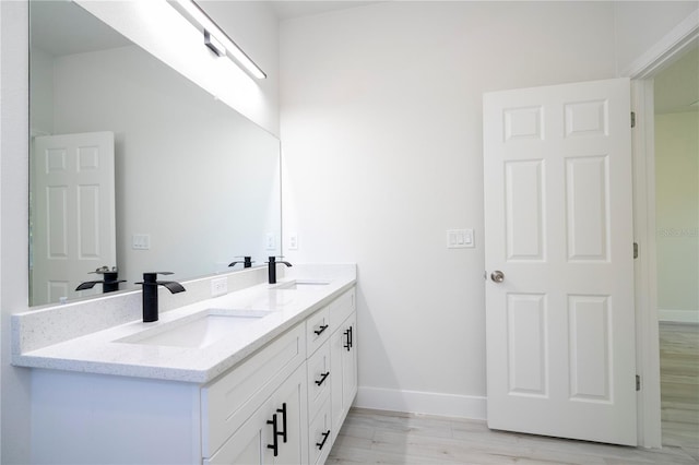 bathroom featuring vanity and hardwood / wood-style floors