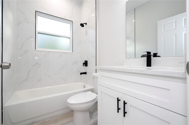 full bathroom with vanity, toilet, and tiled shower / bath combo