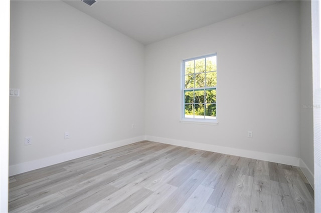 empty room with light hardwood / wood-style flooring