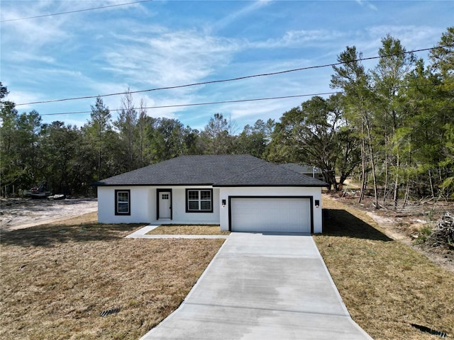 view of front of property with a garage and a front yard