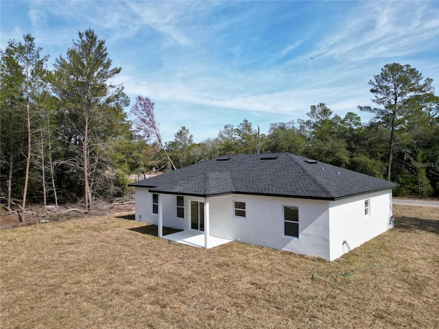 back of house with a yard and a patio area