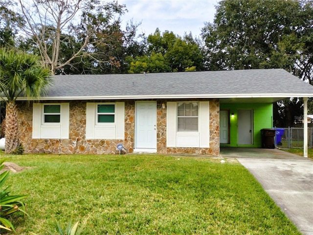 ranch-style home with a carport and a front lawn