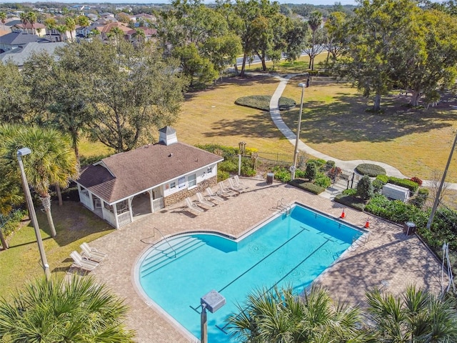 view of pool featuring a lawn and a patio area