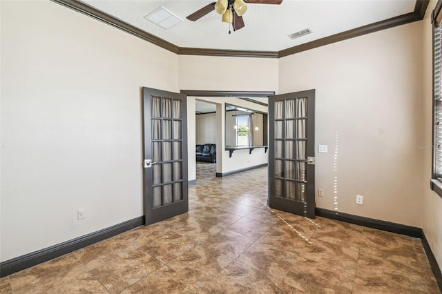 empty room with ornamental molding, a textured ceiling, ceiling fan, and french doors