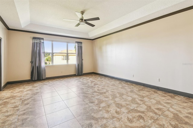 unfurnished room featuring crown molding, ceiling fan, a textured ceiling, and a tray ceiling