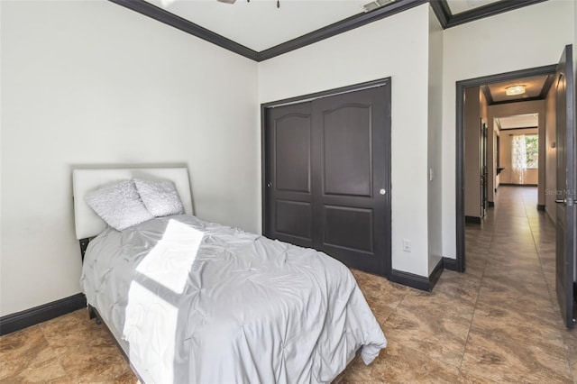 bedroom with crown molding and a closet