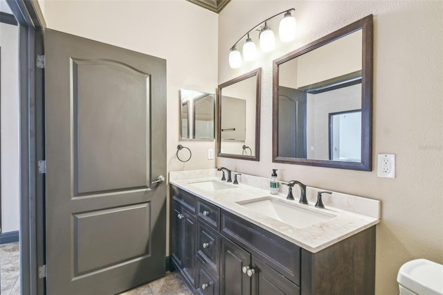 bathroom featuring tile patterned flooring, vanity, and toilet