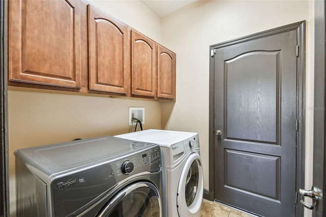 washroom with cabinets, independent washer and dryer, and light tile patterned flooring