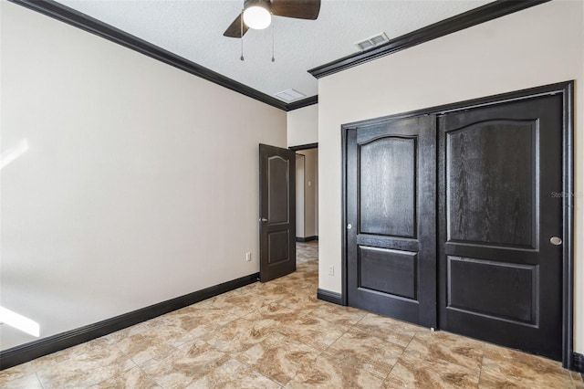 unfurnished bedroom with ornamental molding, a textured ceiling, and ceiling fan