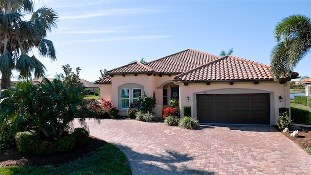 mediterranean / spanish home featuring a garage