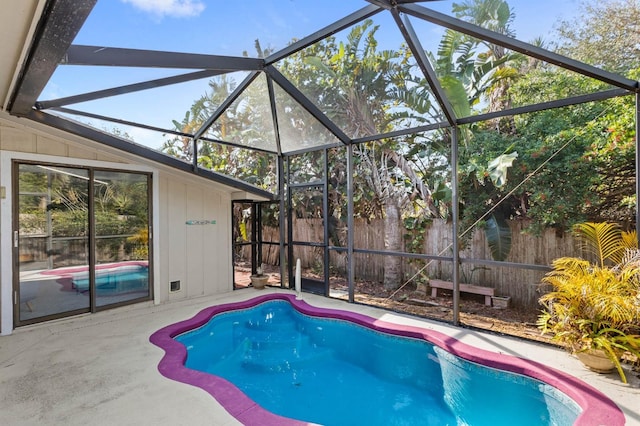 view of swimming pool featuring a lanai and a patio area