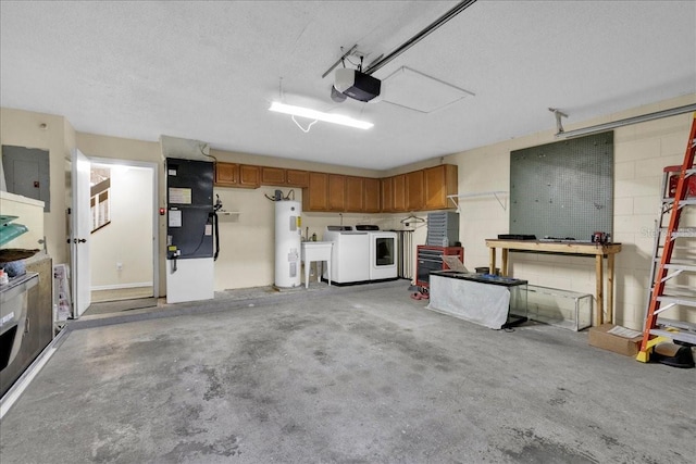 garage with water heater, electric panel, independent washer and dryer, a garage door opener, and a workshop area