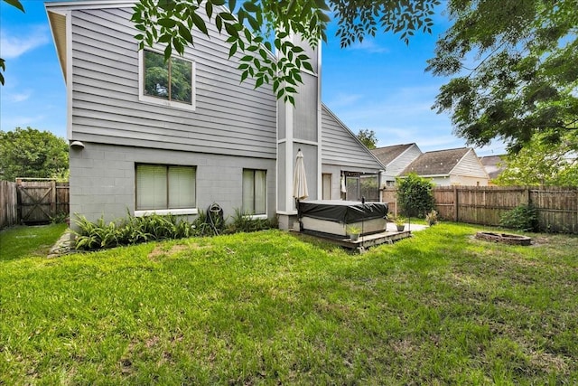 rear view of property with a yard