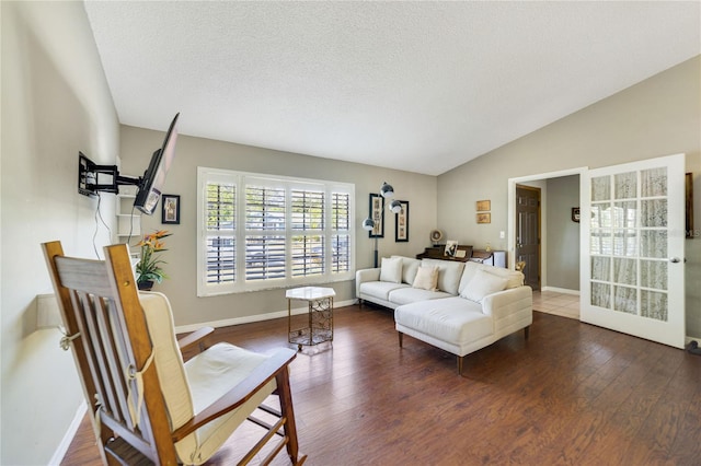 living room featuring vaulted ceiling, dark hardwood / wood-style floors, and a textured ceiling