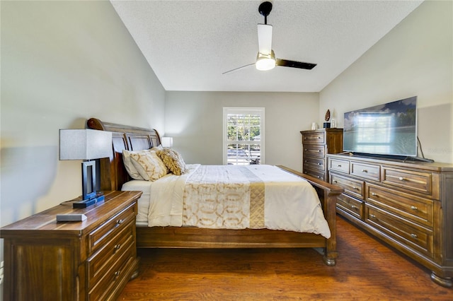 bedroom with dark hardwood / wood-style flooring, ceiling fan, and a textured ceiling