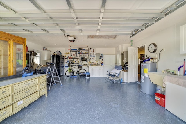 garage with a garage door opener, sink, and water heater