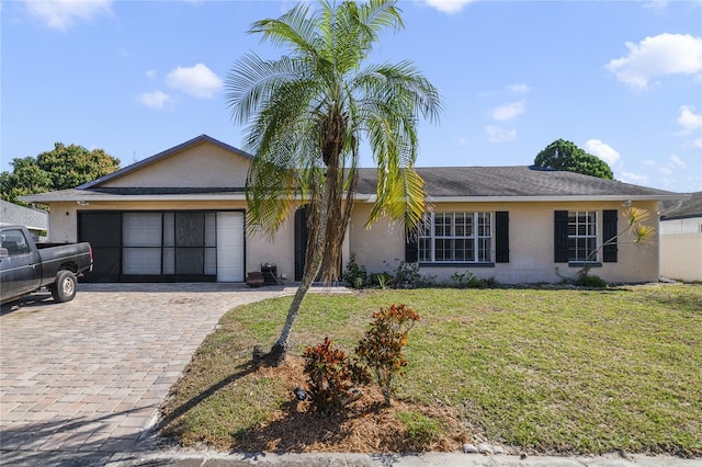 single story home featuring a garage and a front yard