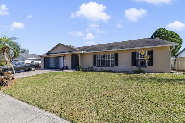 ranch-style home with a garage and a front lawn