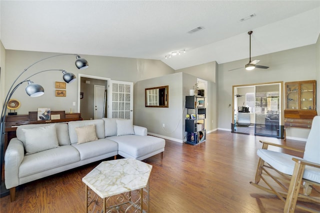 living room featuring ceiling fan, lofted ceiling, and dark hardwood / wood-style flooring