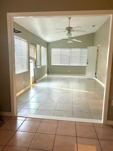 2537 Lanier Rd, Kissimmee, FL 34744 - empty room with lofted ceiling, ceiling fan, light tile patterned flooring, and baseboards