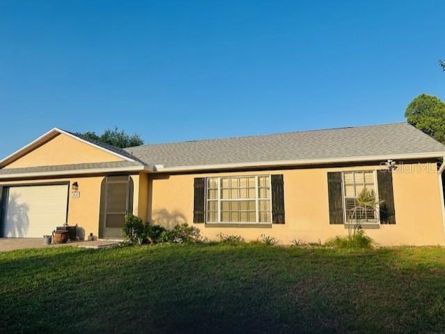 2537 Lanier Rd, Kissimmee, FL 34744 - single story home featuring a garage, a front yard, and stucco siding