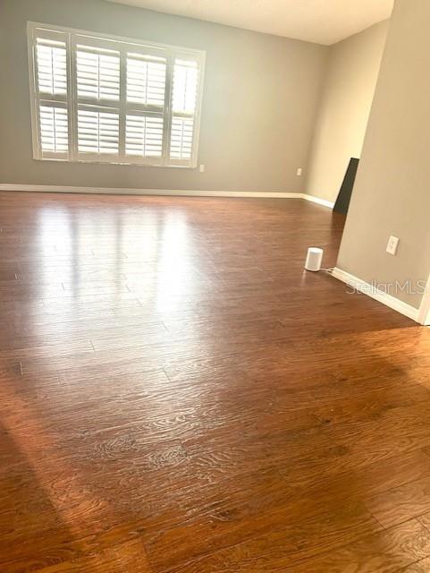 2537 Lanier Rd, Kissimmee, FL 34744 - unfurnished room featuring dark wood-style flooring and baseboards