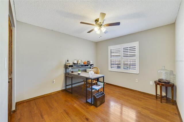 2537 Lanier Rd, Kissimmee, FL 34744 - office with ceiling fan, wood finished floors, a textured ceiling, and baseboards