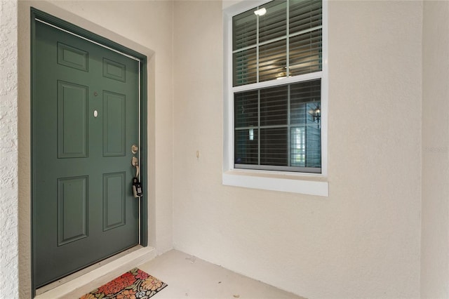 doorway to property with stucco siding