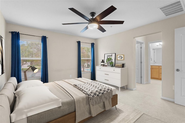 bedroom with baseboards, multiple windows, visible vents, and light colored carpet