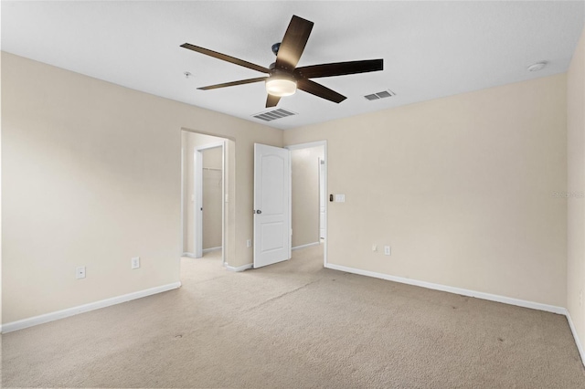 unfurnished room featuring light carpet, visible vents, and baseboards