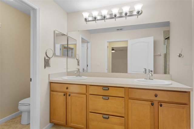 full bath with toilet, double vanity, visible vents, and a sink